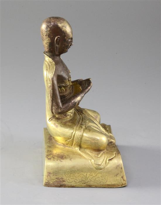 A Chinese gilt copper seated figure of a luohan, probably Qing dynasty, height 15cm